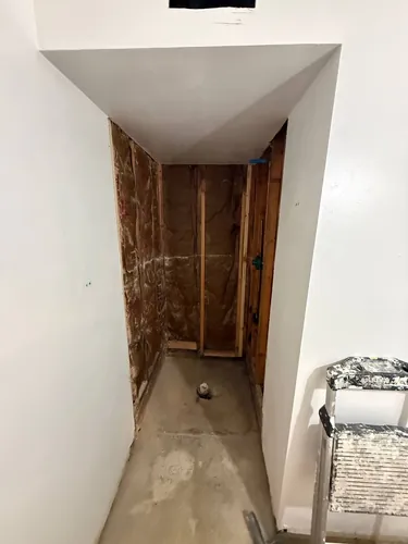Old shower enclosure demolished back to framing and insulation