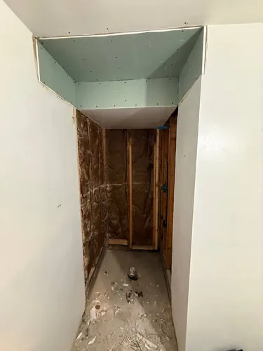 Rebuilt shower soffit boarded in moisture-resistant drywall