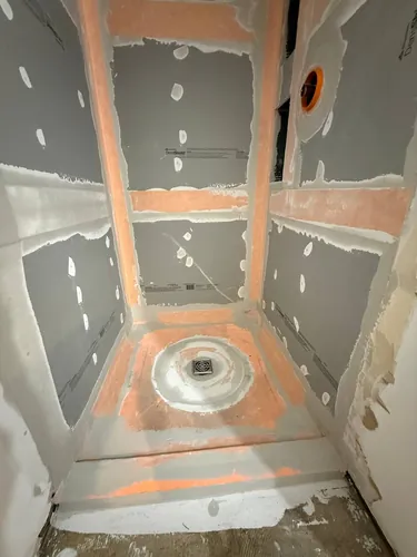Board seams and corners banded and sealed before waterproofing