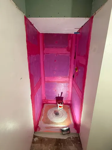 Shower enclosure fully coated in liquid waterproofing membrane