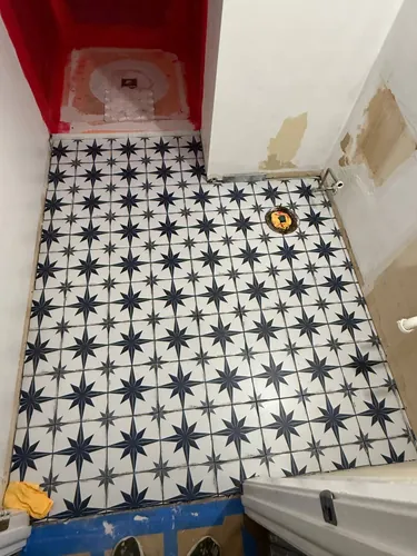 Patterned porcelain floor tile laid across the full bathroom