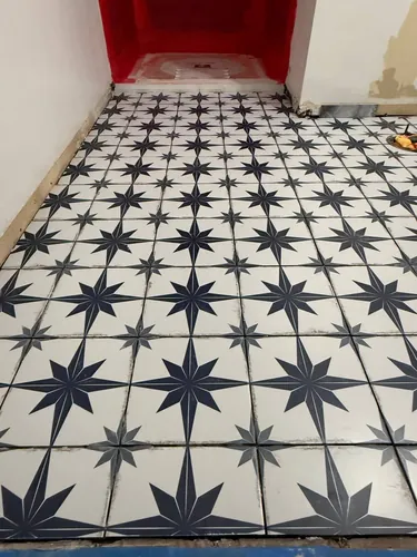 Close-up of the star-pattern porcelain floor tile and grout lines