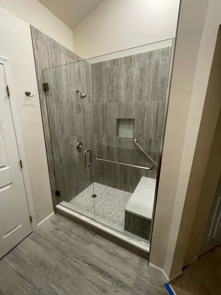 Walk-in shower with bench and glass door