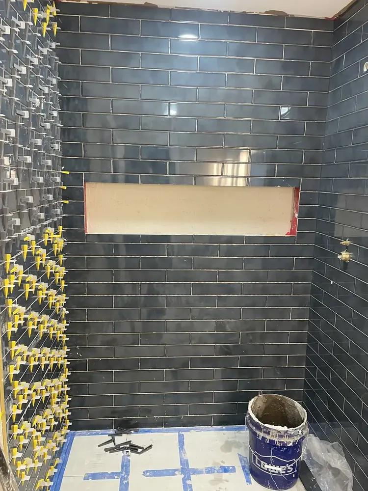 Bathroom floor tile installation in progress