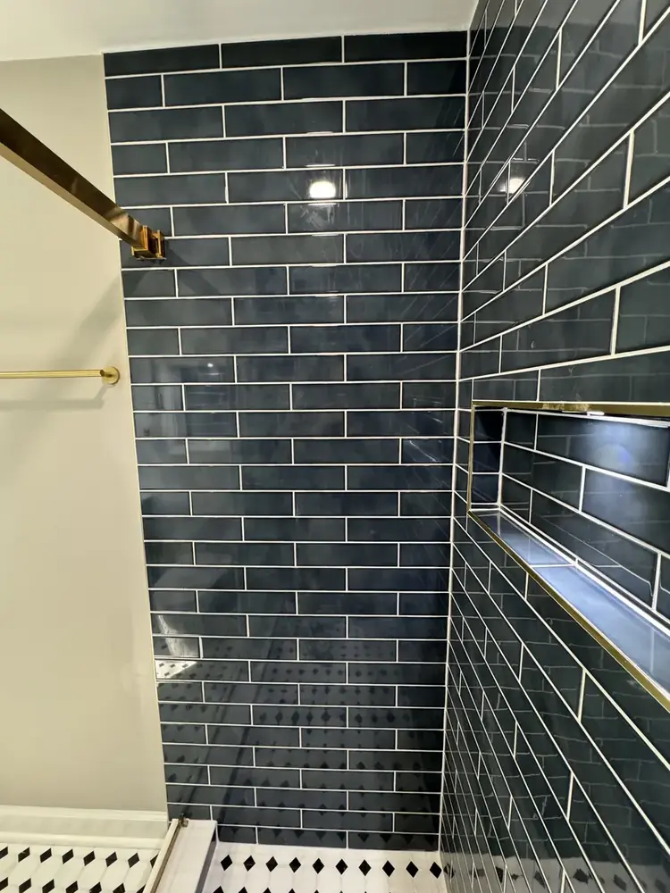 Finished bathroom view with shower and vanity