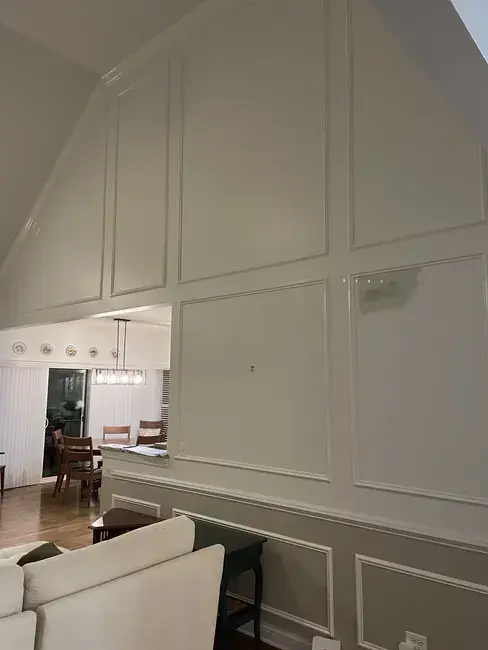 Finished room view with crown moulding and framed wall panels