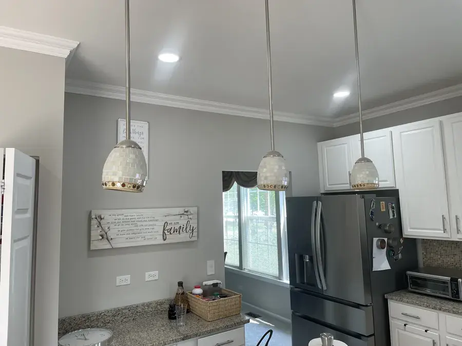 Dining area with crown moulding and wall panel mouldings